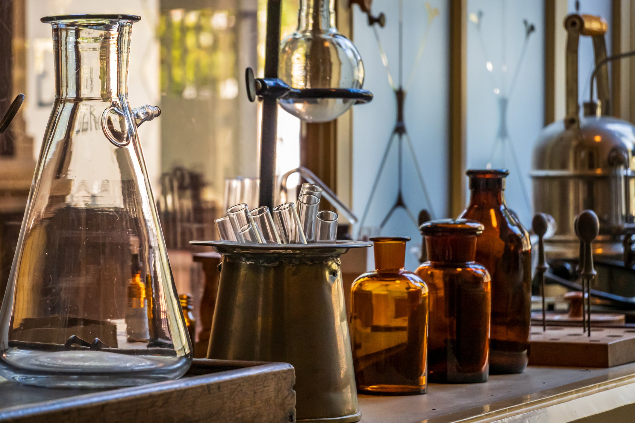 Laboratory setup with glass beakers and bottles on a wooden surface.